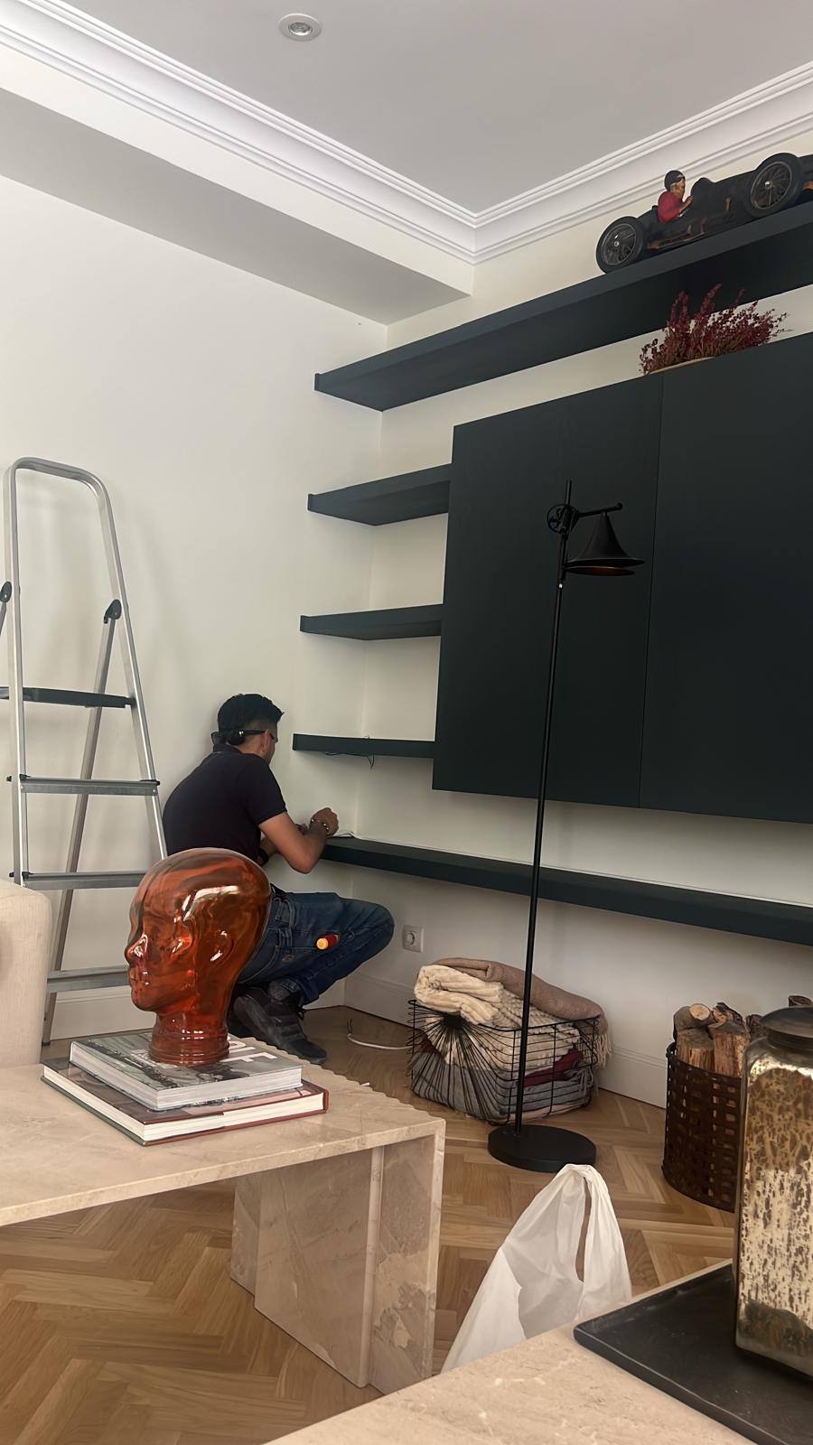 Profesional trabajando en la instalación de iluminación de un salón